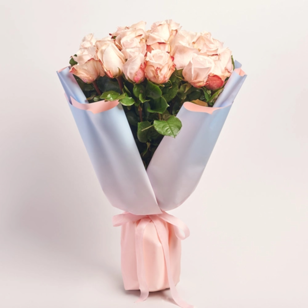Soft peach rose bouquet wrapped in pastel blue paper with a blush pink ribbon