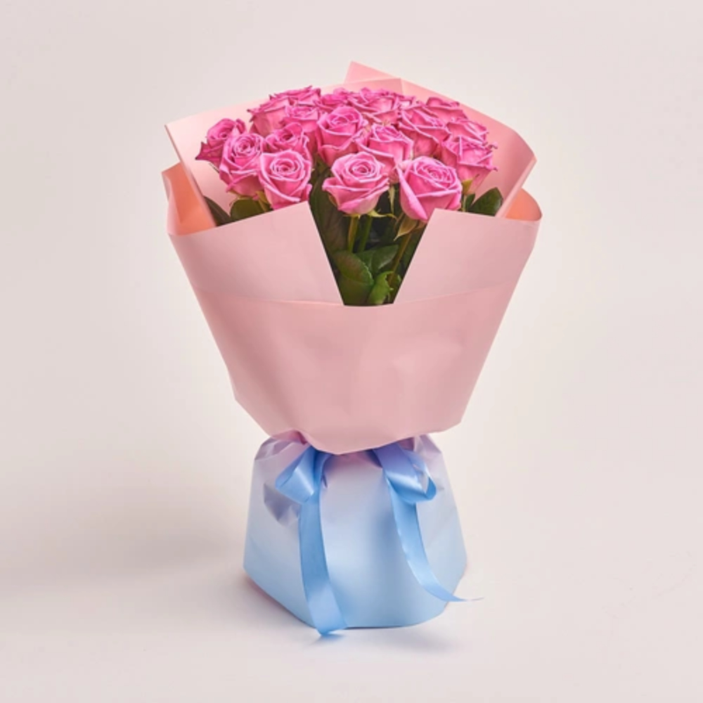Fresh pink roses bouquet wrapped in soft blush paper with a pastel blue ribbon, perfect for romantic gifting and special occasions.