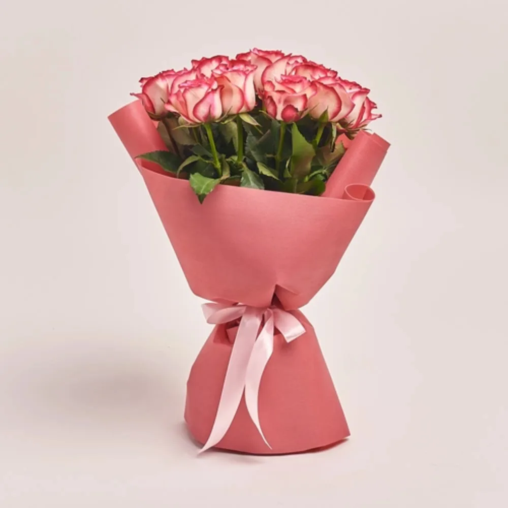 Elegant bouquet of fresh bi-color pink roses wrapped in premium blush paper with a soft ribbon, ideal for romantic gifts and special occasions.