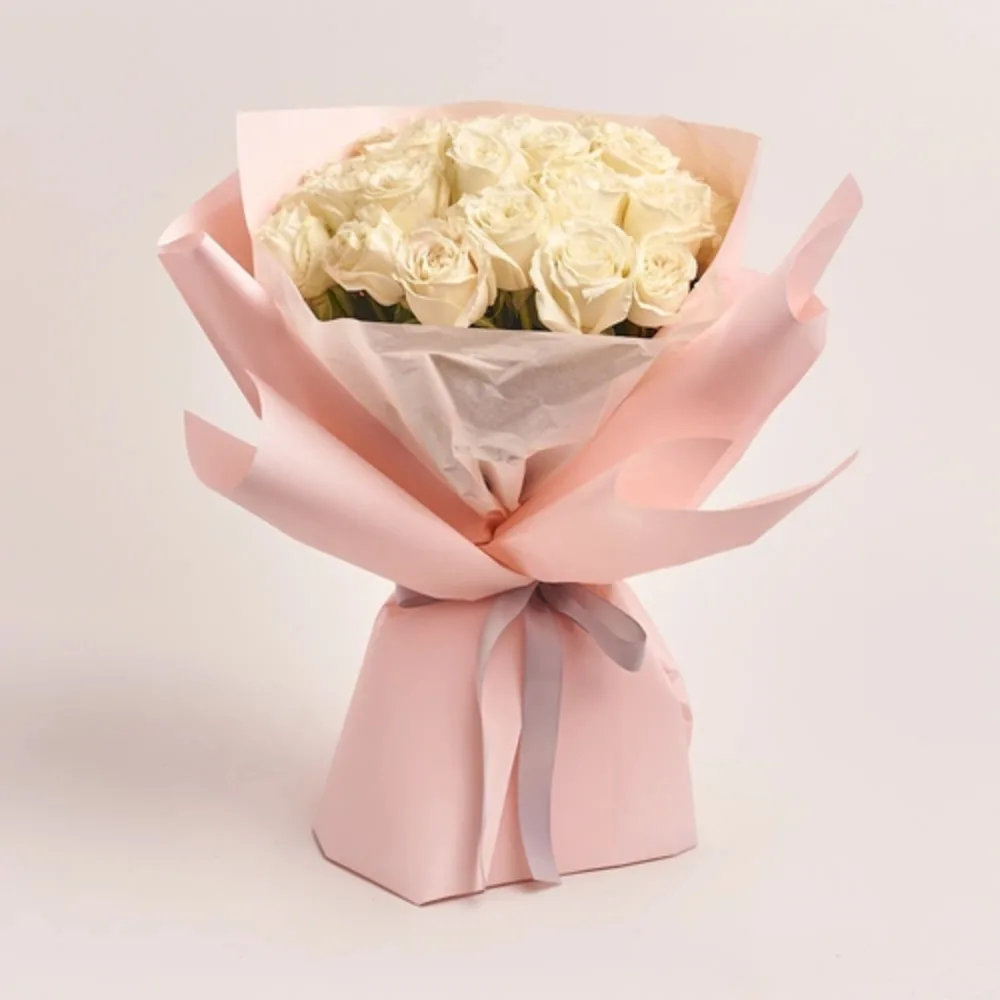 Fresh bouquet of pink roses wrapped in elegant green paper with a soft pink ribbon, perfect for romantic gifting and special occasions.