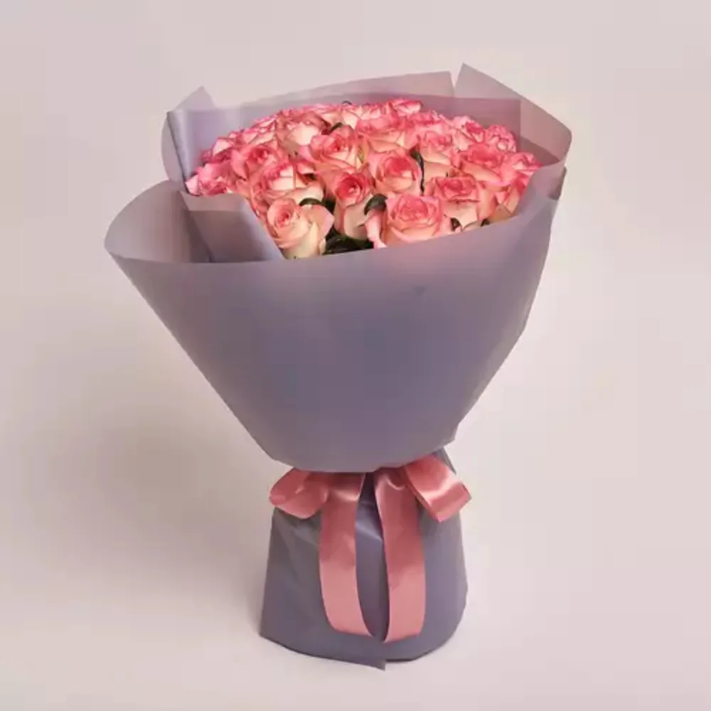 Luxury bouquet of pink and white roses wrapped in elegant grey paper with a satin pink ribbon, premium floral gift by Favish Blooms Dubai