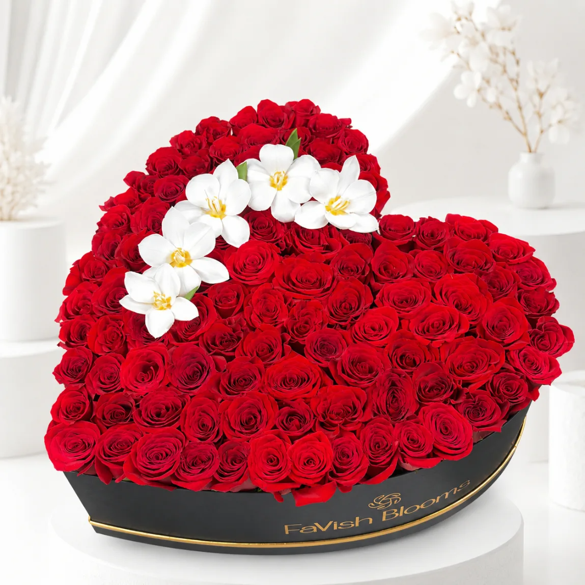 Luxurious red rose bouquet in elegant black wrapping with gold ribbon, perfect romantic flower gift.
