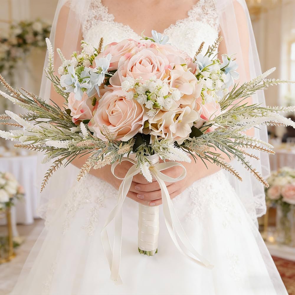Elegant bridal bouquet with blush pink roses, soft blue delphiniums, delicate white florals, and pampas accents, beautifully finished with ivory ribbon for a timeless wedding celebration.