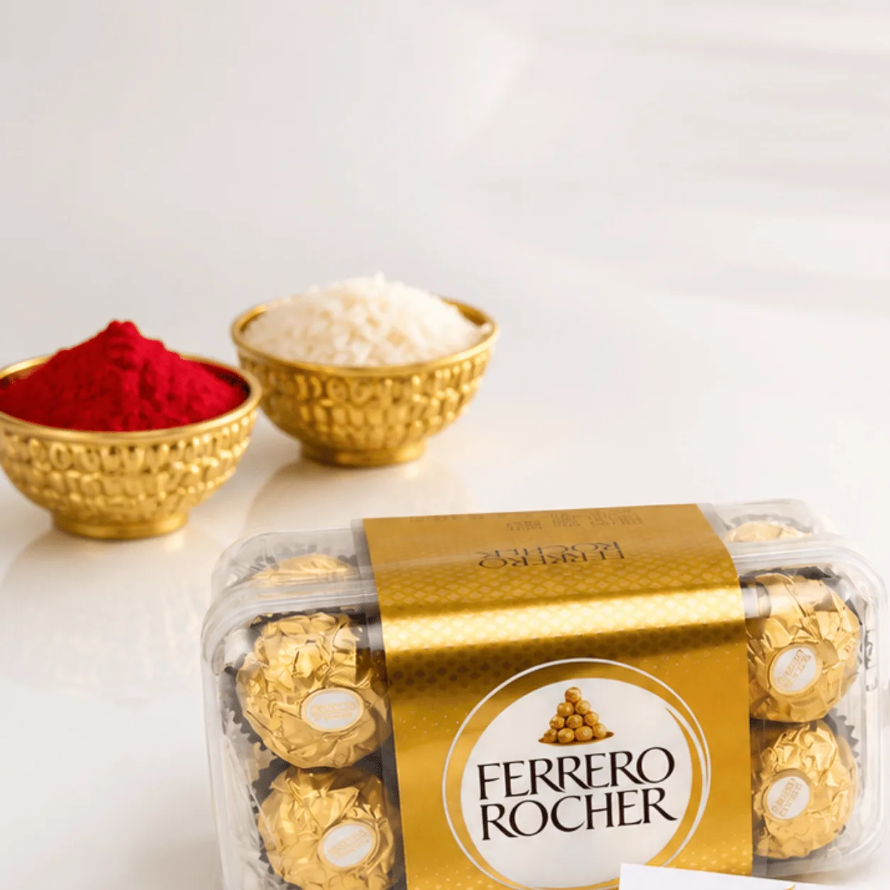 Luxury Raksha Bandhan gift box featuring Ferrero Rocher chocolates and golden bracelet Rakhi