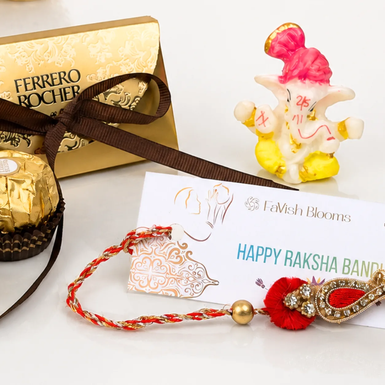 Traditional Paisley Rakhi gift set with Ferrero Rocher and Lord Ganesha idol