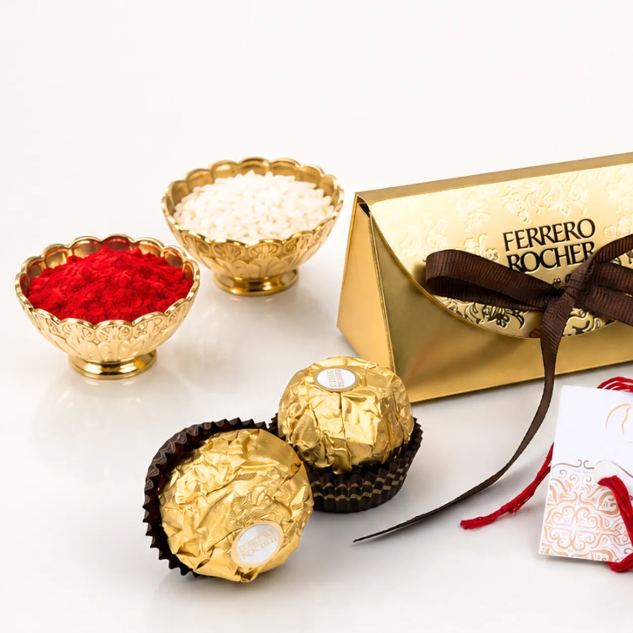 Close-up of elegant Om Rakhi with premium Indian sweets