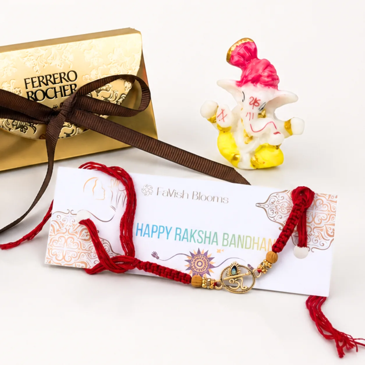 Om Rakhi sweet gift arrangement with decorative festive accessories