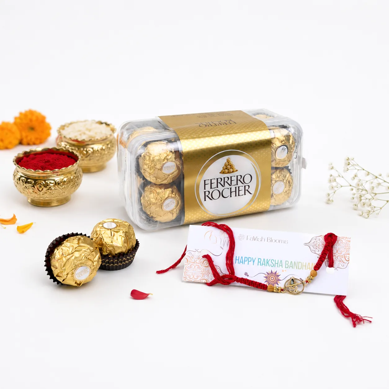 Ferrero Rocher chocolate box with elegant Om Rakhi, Ganesha idol, roli, chawal, and Raksha Bandhan card.