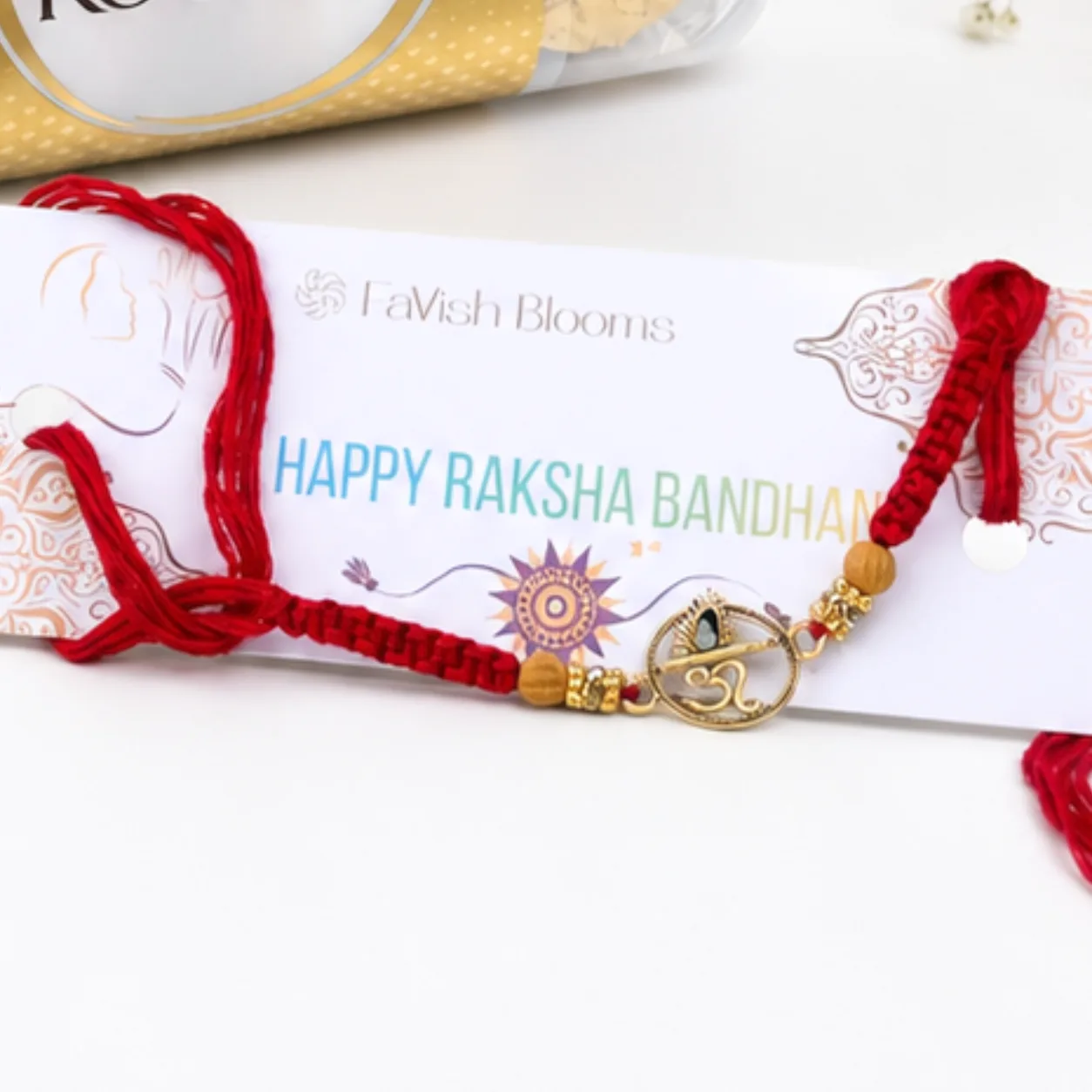 Om Rakhi celebration gift set with Ferrero Rocher chocolates, Lord Ganesha idol, roli, and chawal.