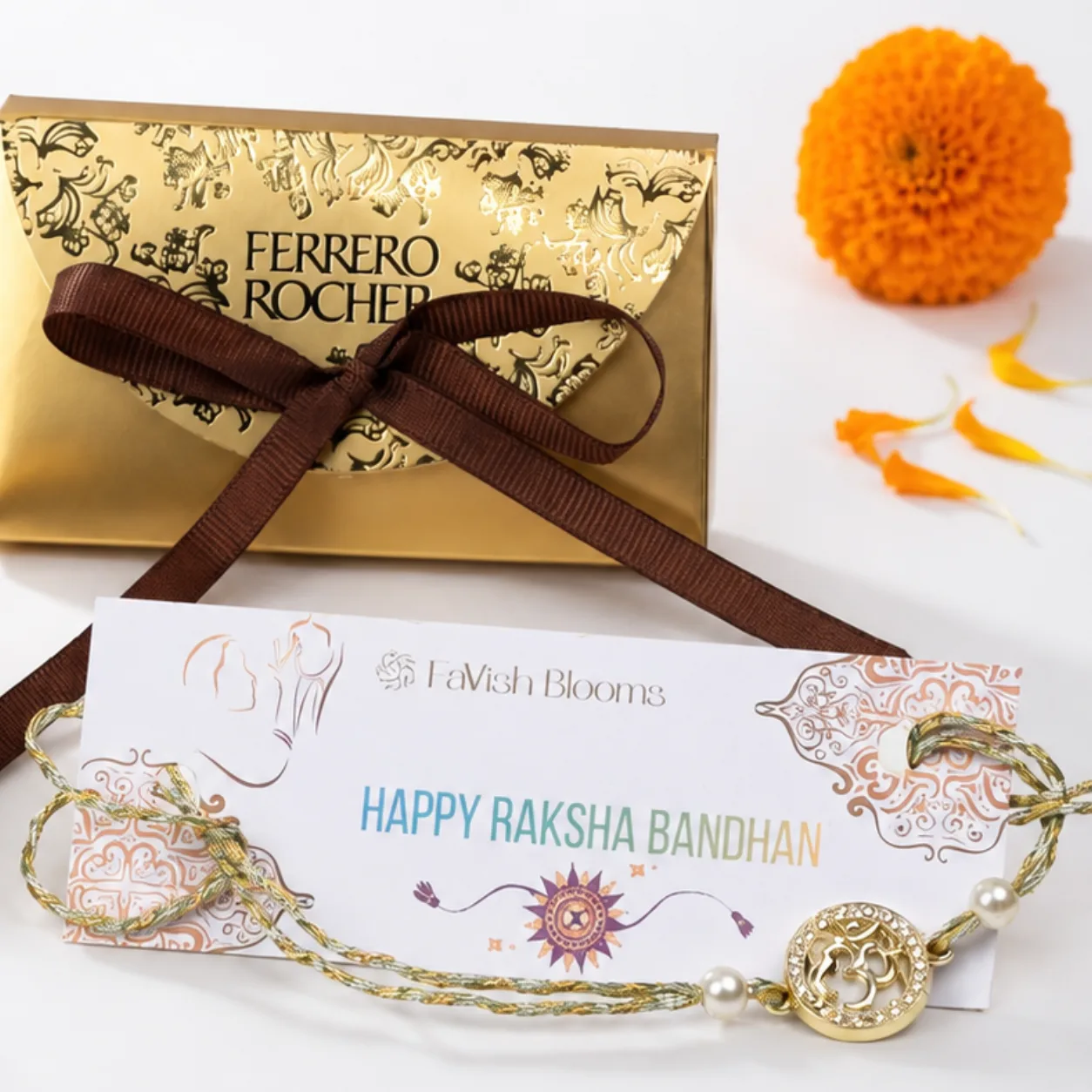 Om Rakhi with Ferrero Rocher chocolates, decorative Ganesha idol, roli, chawal, and Raksha Bandhan greeting card.