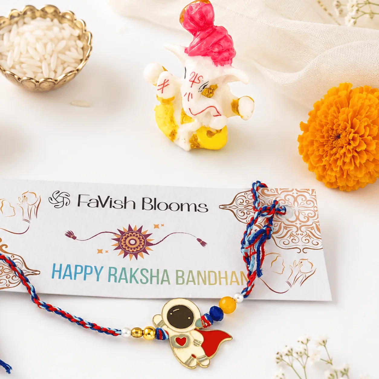 Colourful astronaut kids Rakhi with decorative Lord Ganesha idol for Raksha Bandhan