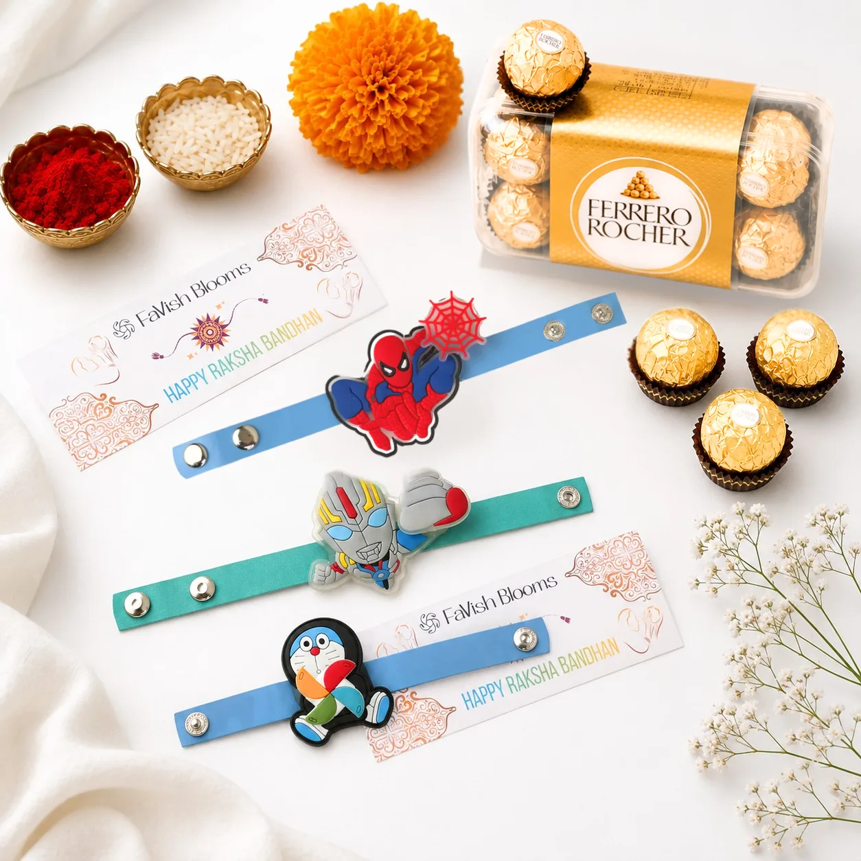 Triple Character Rakhi & Ferrero Set with 3 kids character rakhis, Ferrero Rocher chocolates, roli chawal and Raksha Bandhan greeting card on a white background.