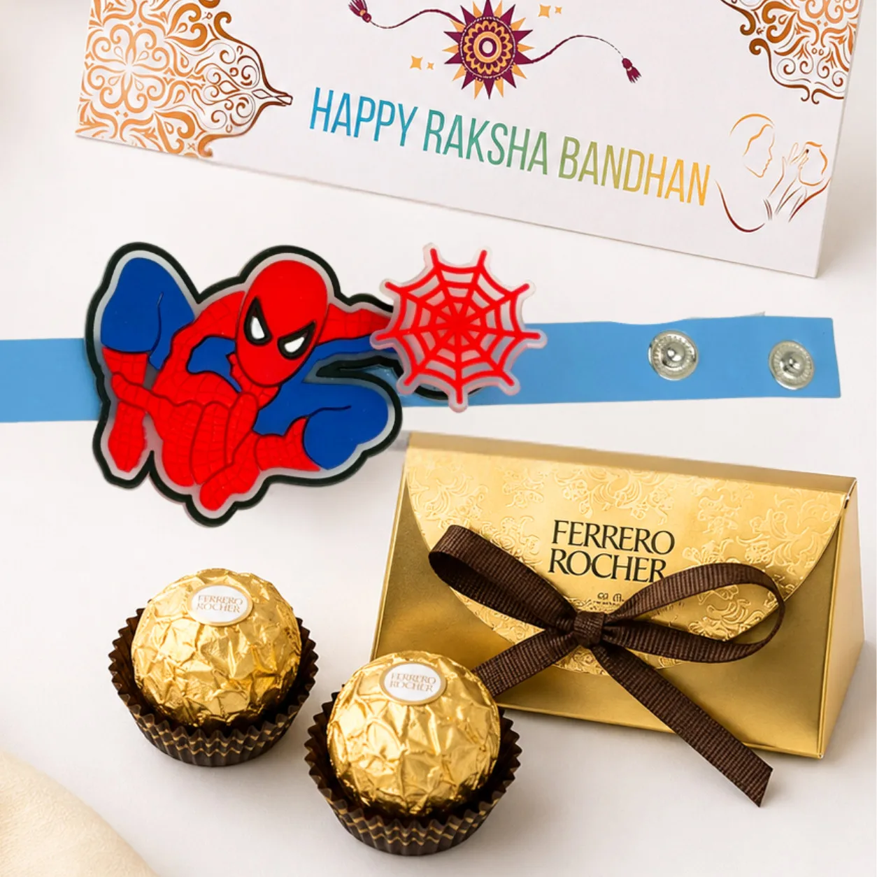 Close-up of colourful Spiderman spinner kids rakhi paired with premium Ferrero Rocher chocolates.