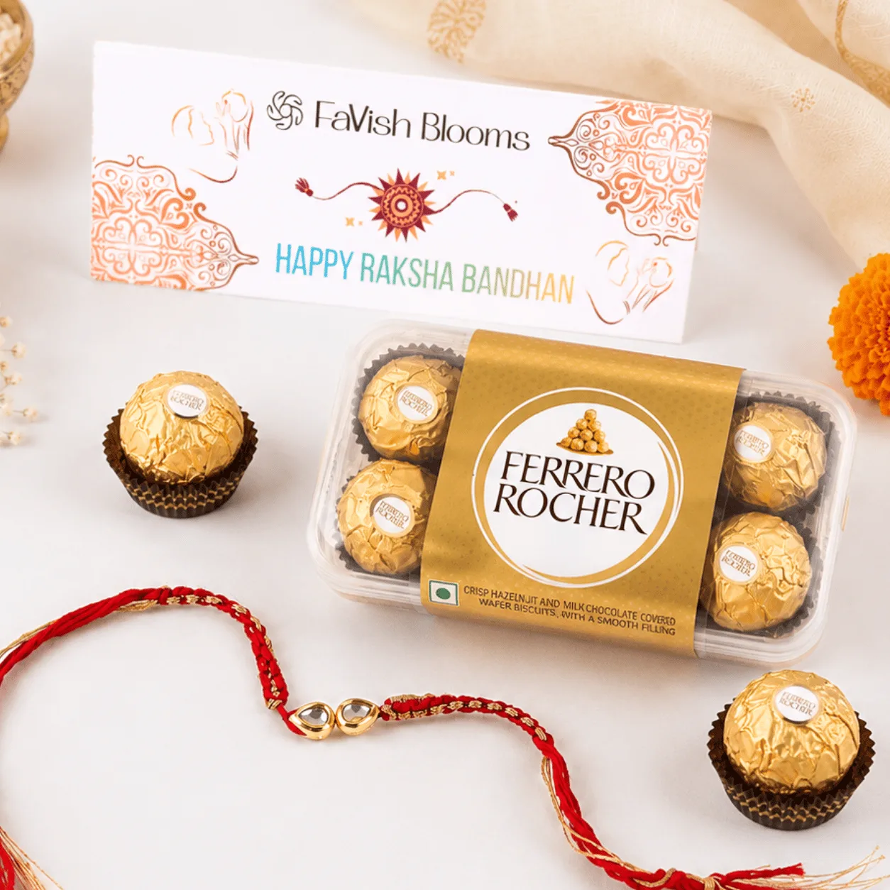 Rakhi thread with Ferrero Rocher chocolates and a "Happy Raksha Bandhan" card from FaVish Blooms.