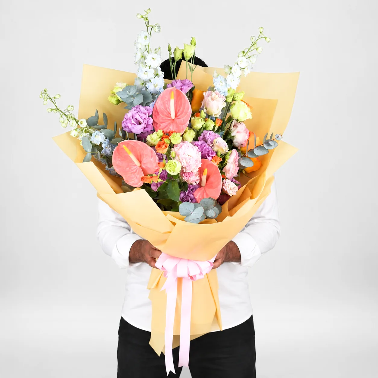 Luxury Anthurium bouquet featuring pastel blooms in a stylish hand-tied arrangement
