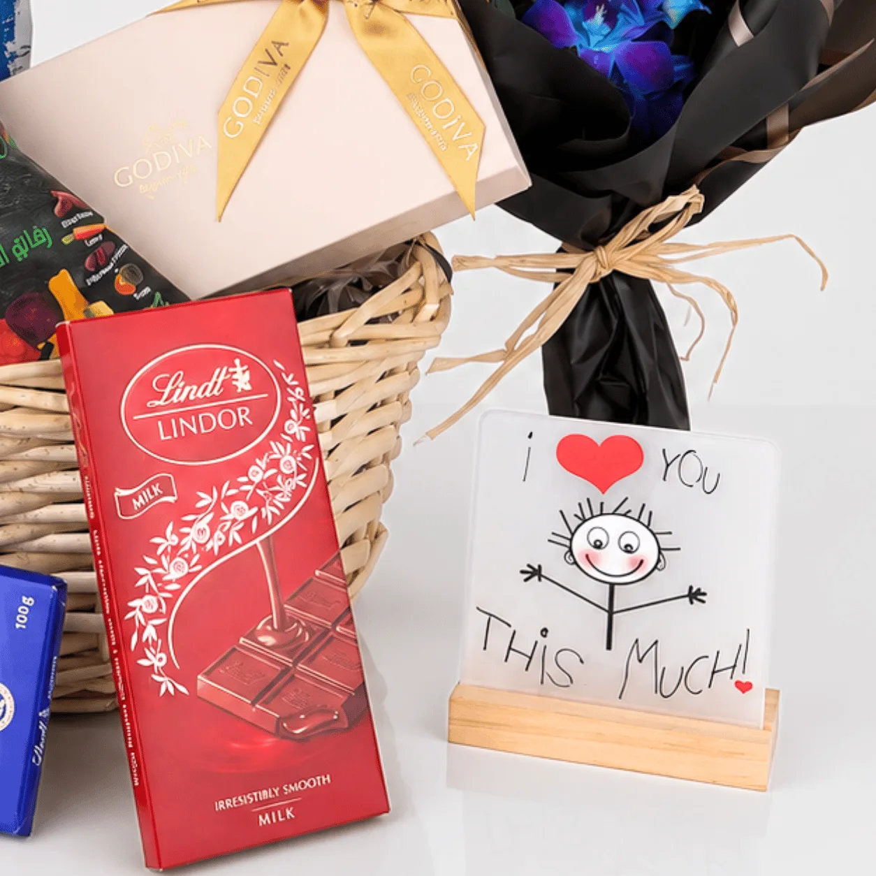 Elegant chocolate and flower gift basket with Godiva, Lindt and stylish floral presentation