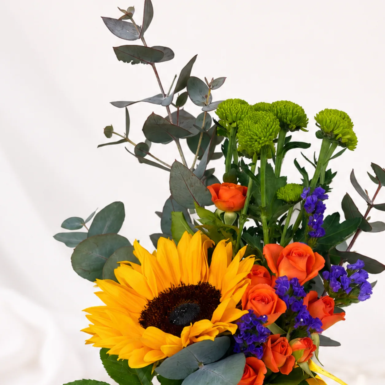 Raksha Bandhan Floral Mug with vibrant fresh flowers, festive ceramic mug and elegant ribbon decoration