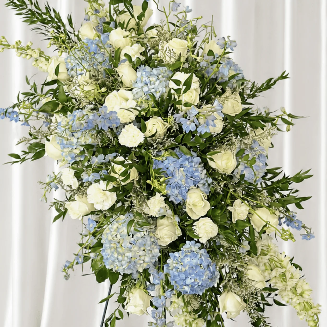 Premium blue and white floral arrangement in a metallic stand for luxury gifting and special occasions