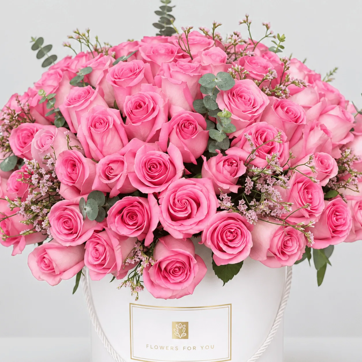 Elegant 101 pink rose box arrangement with eucalyptus and pink fillers in Dubai.