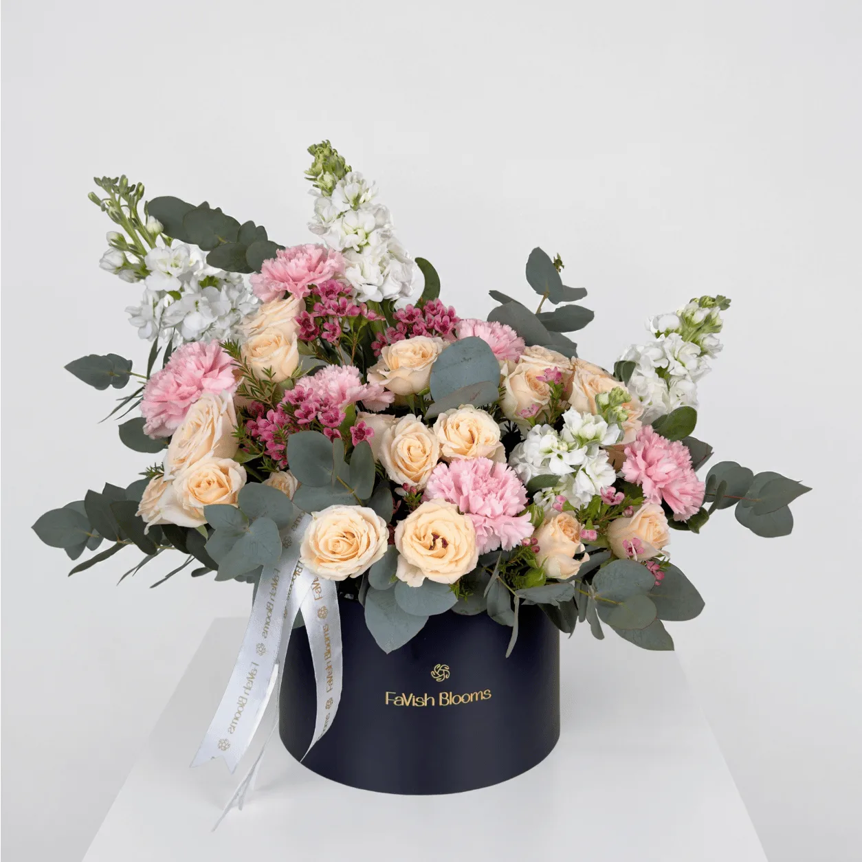Elegant pink and peach floral box arrangement with fresh roses and delicate blooms.