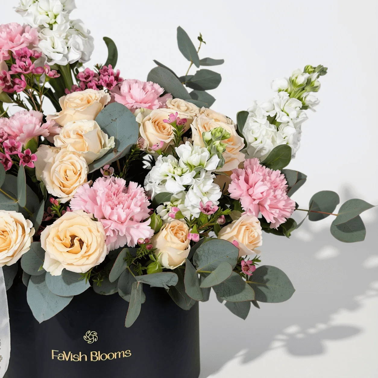Romantic pink and peach floral box with fresh roses, perfect for elegant gifting in Dubai.