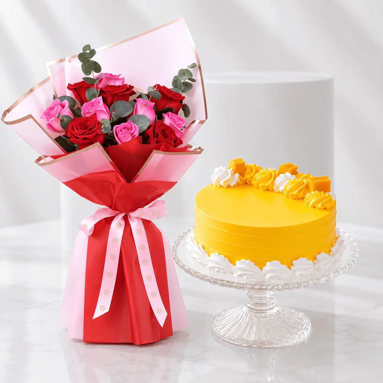 Fresh roses and 500 g mango vanilla cake combo for birthdays and anniversaries in Dubai.