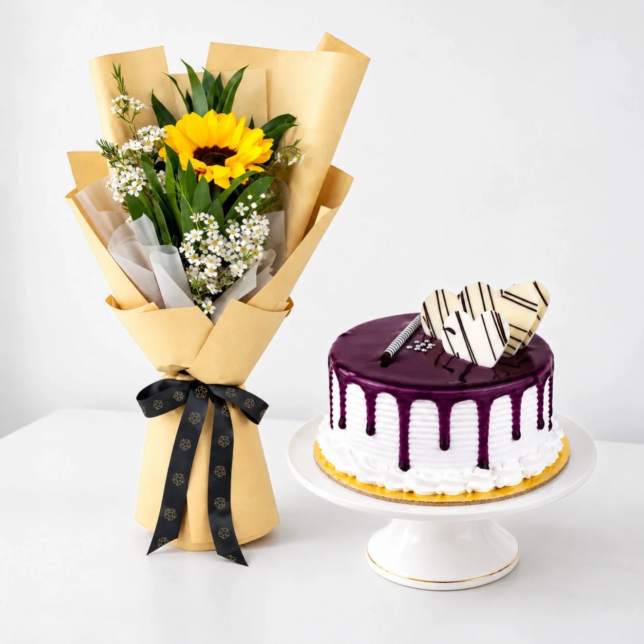 Cheerful sunflower bouquet with 500 g blueberry vanilla cake for gift delivery in Dubai.