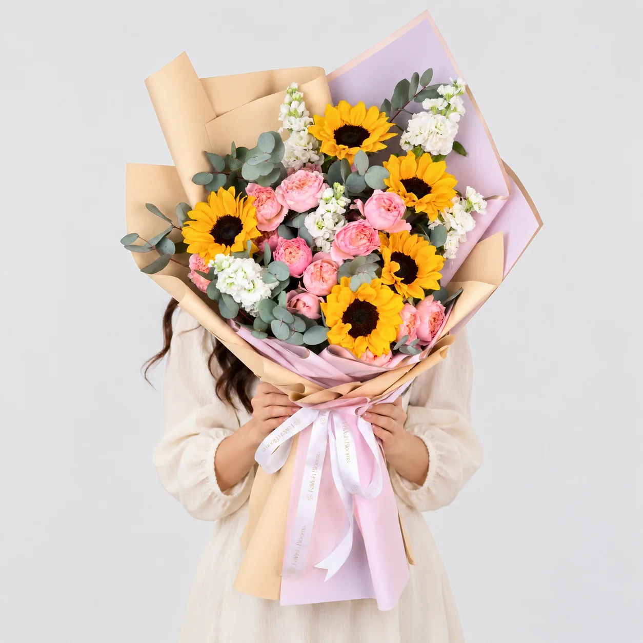 Elegant bouquet featuring vibrant sunflowers and delicate Juliet spray roses.