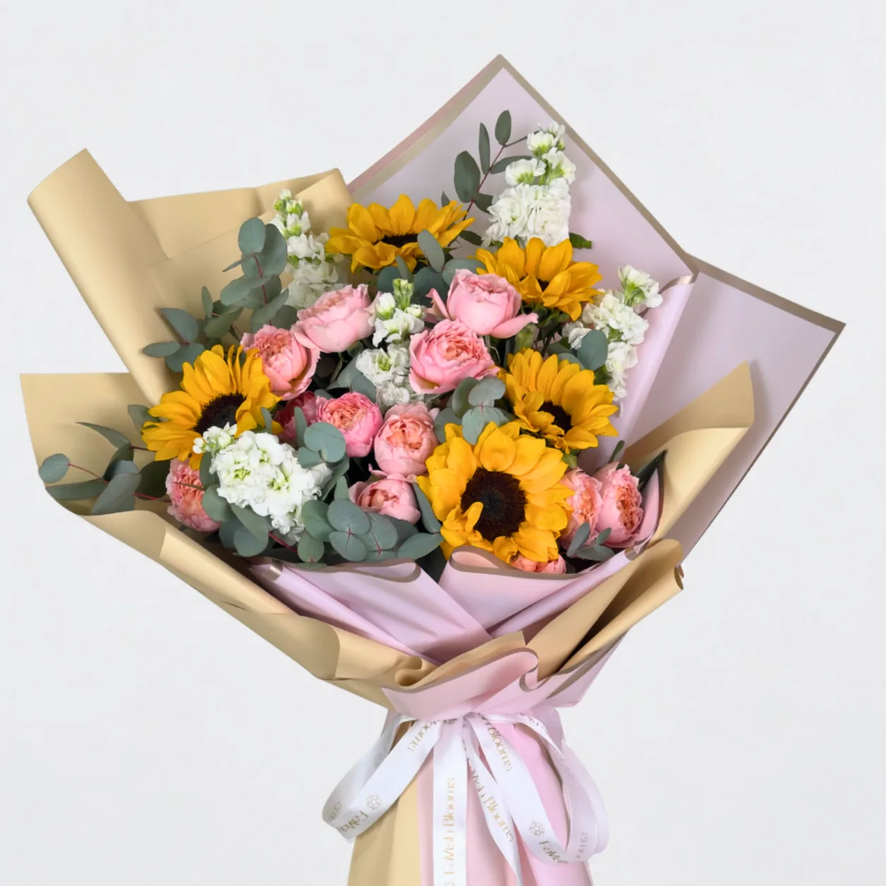 Luxury sunflower bouquet with Juliet spray roses and fresh foliage, available for delivery in Dubai.