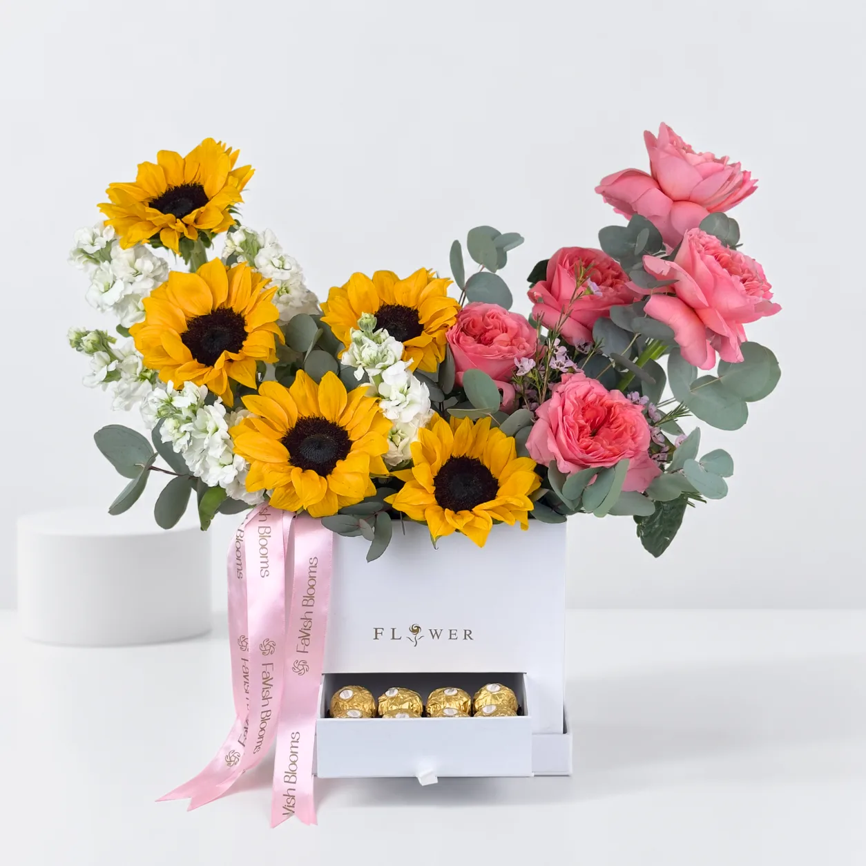 Luxury white flower box featuring sunflowers, O’Hara roses and premium chocolates.