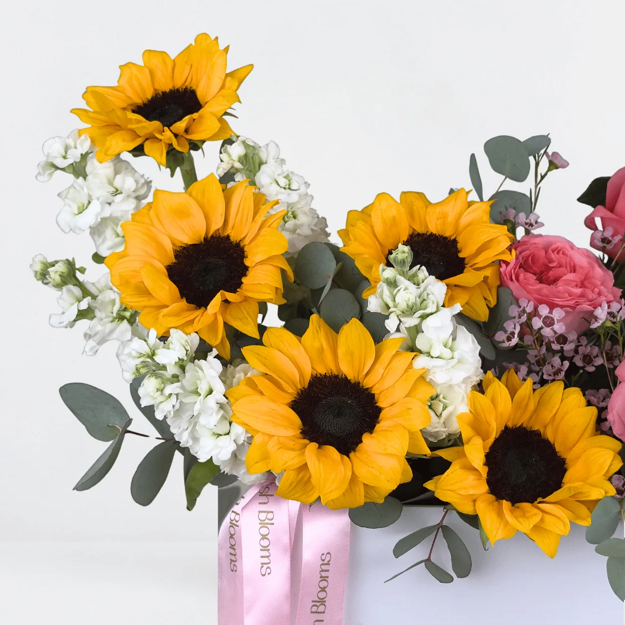 Premium sunflower and O’Hara rose arrangement with Ferrero Rocher chocolates in an elegant white gift box.