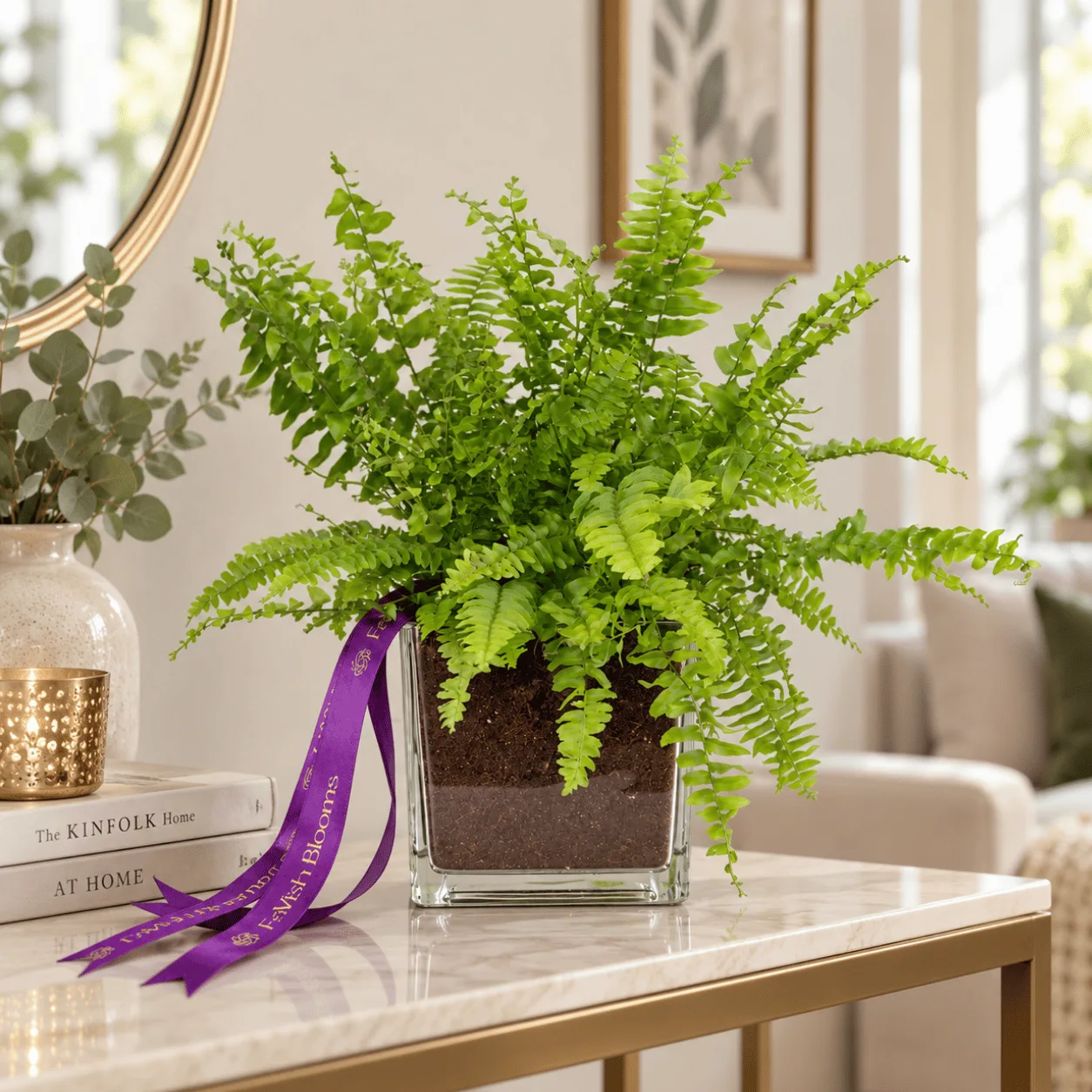 Green Fern Plant in Glass Vase with Decorative Pebbles