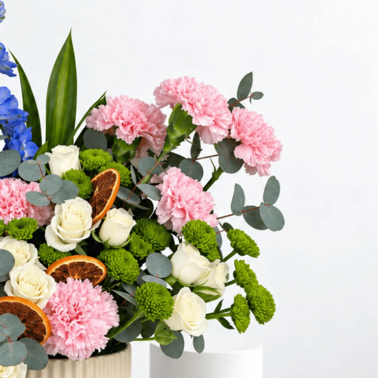Whispers of Spring mixed flower arrangement with eucalyptus and dried orange slices for anniversary gifts.