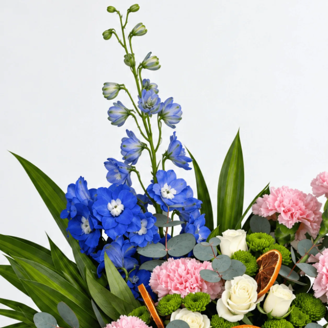 Pink, white and blue flowers in a ceramic pot for congratulations and housewarming celebrations.
