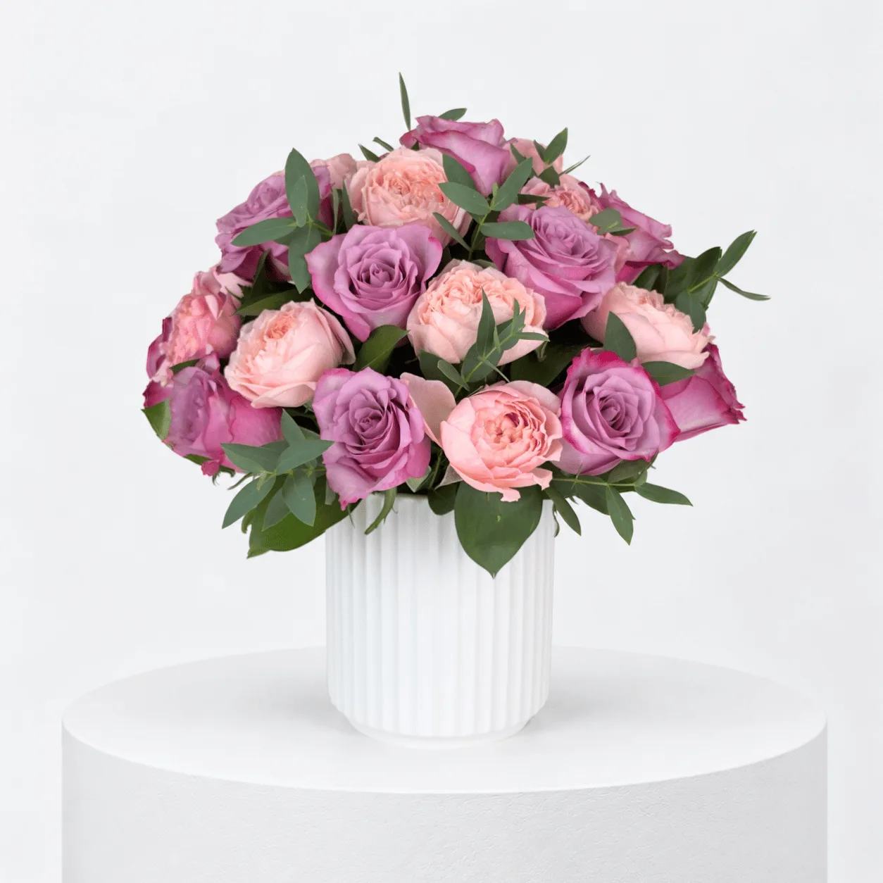 Juliette Rose 21 Purple Majesty arrangement in a white ribbed ceramic pot for birthday gifting.