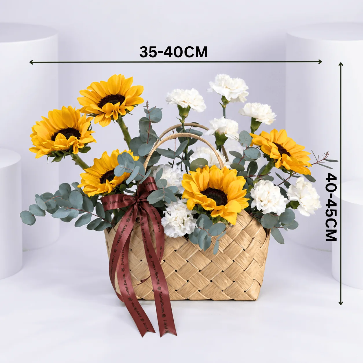 Luxury sunflower and white carnation flower basket with fresh greenery and an elegant FaVish Blooms ribbon.