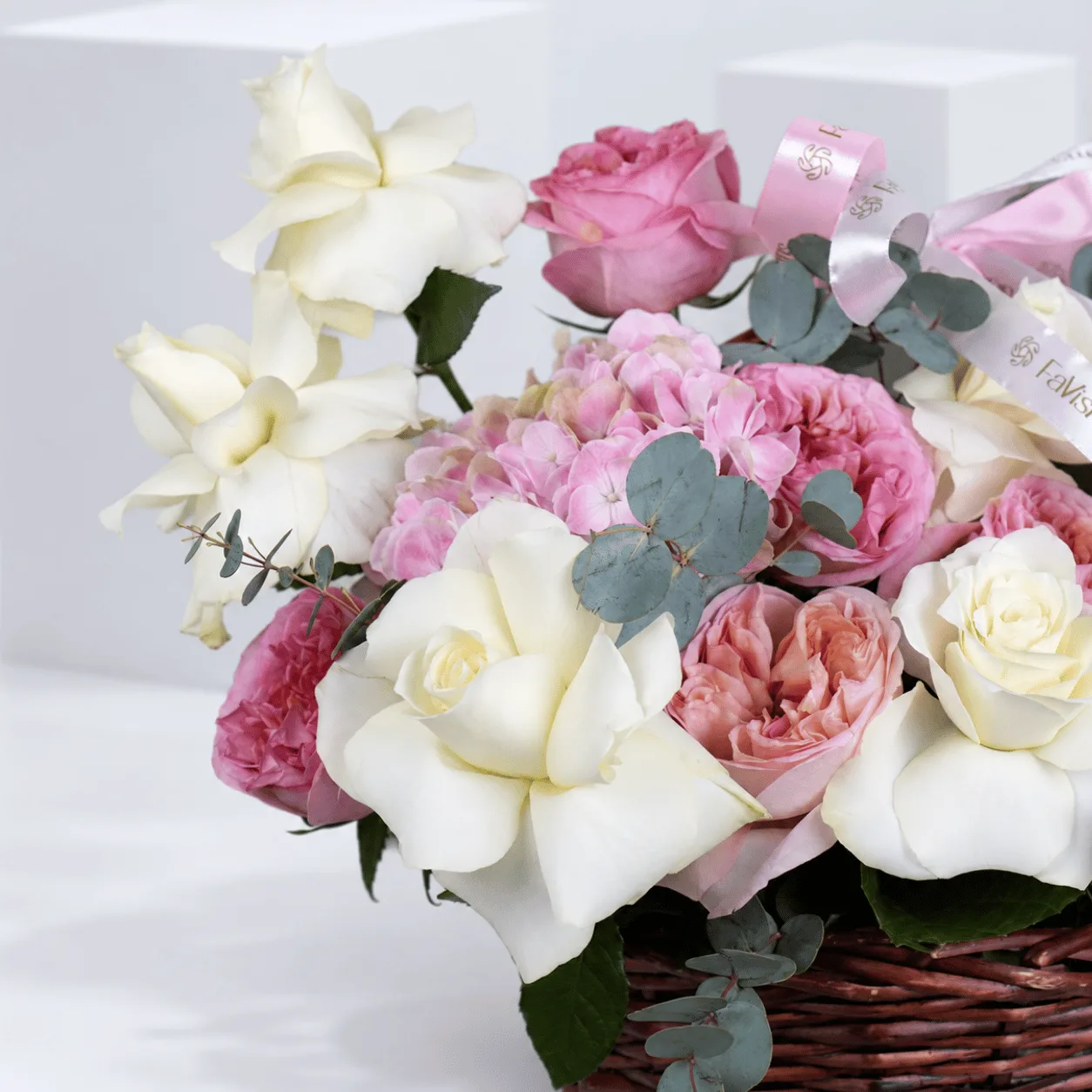 Elegant pink rose and hydrangea flower basket with a signature FaVish Blooms ribbon, perfect for luxury gifting in Dubai.