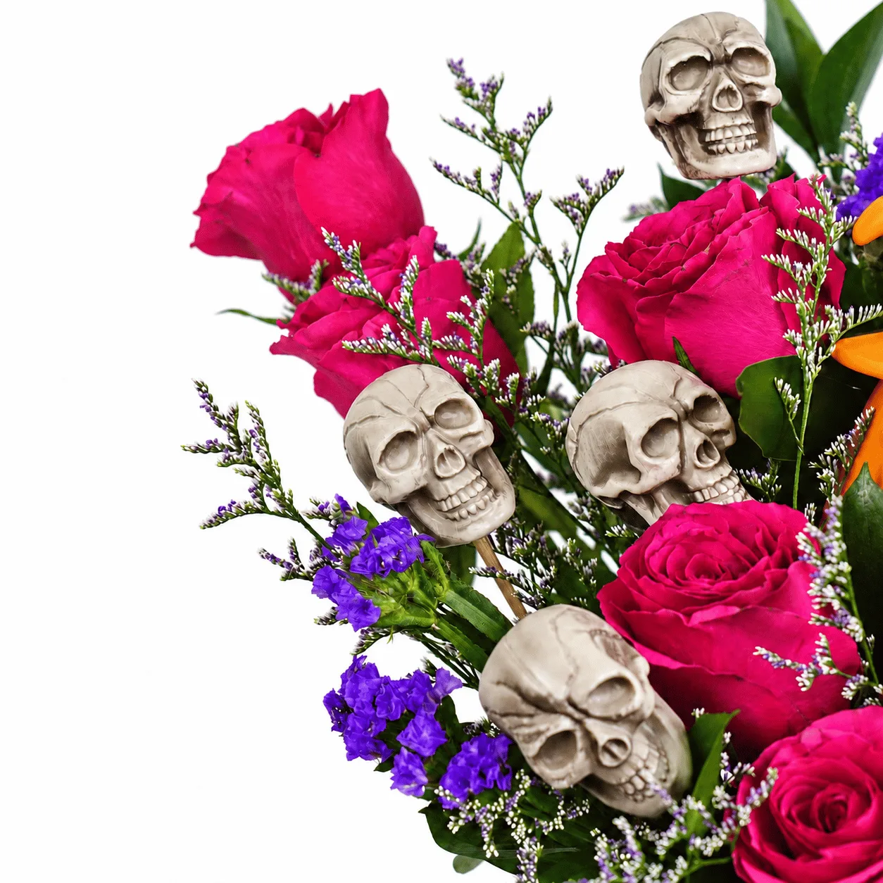 Close-up of fresh pink roses and spooky skeleton decorations in a Haunted Halloween Flower Bucket.