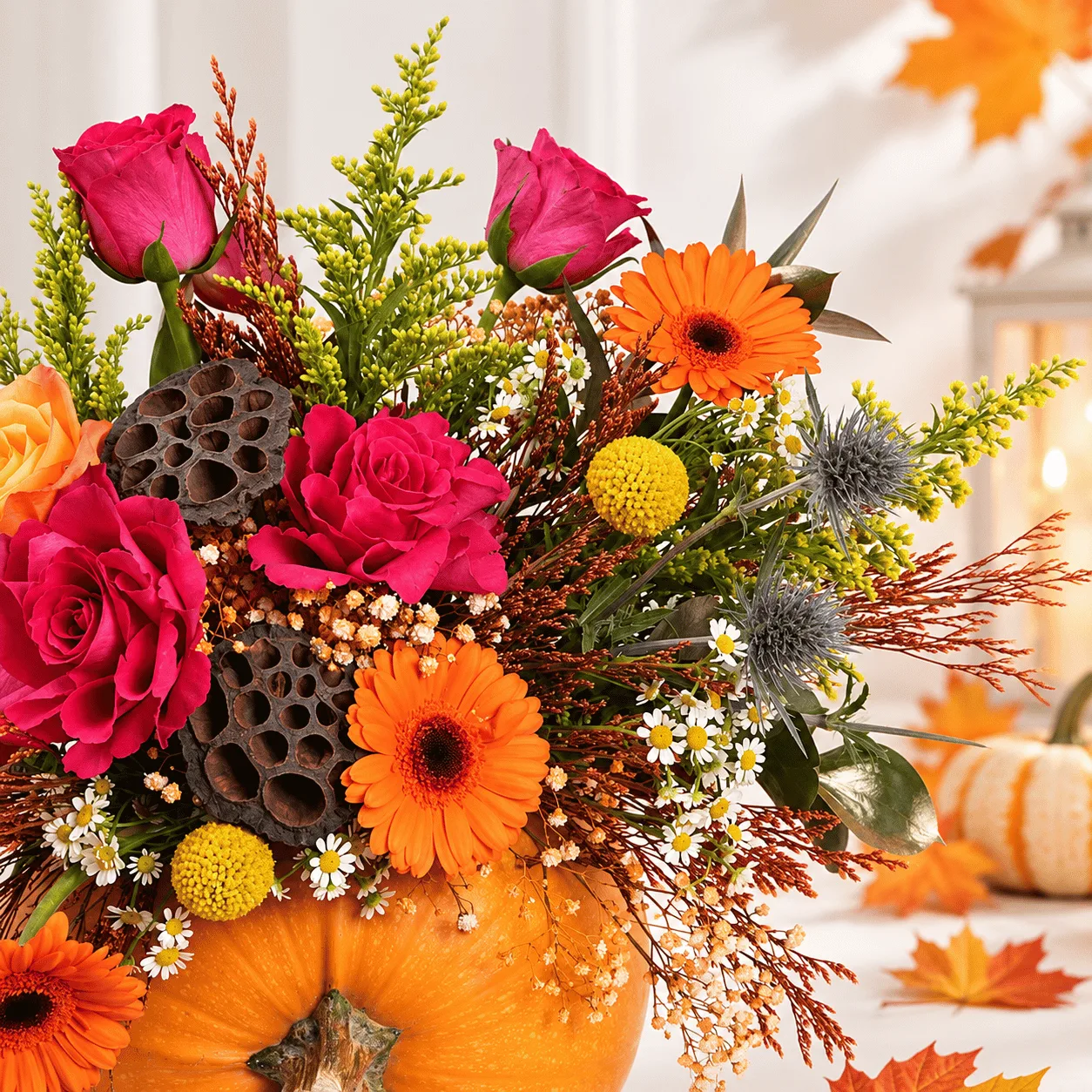 Elegant Halloween Pumpkin Floral Arrangement with orange blooms, autumn greenery, and festive Halloween decorations.