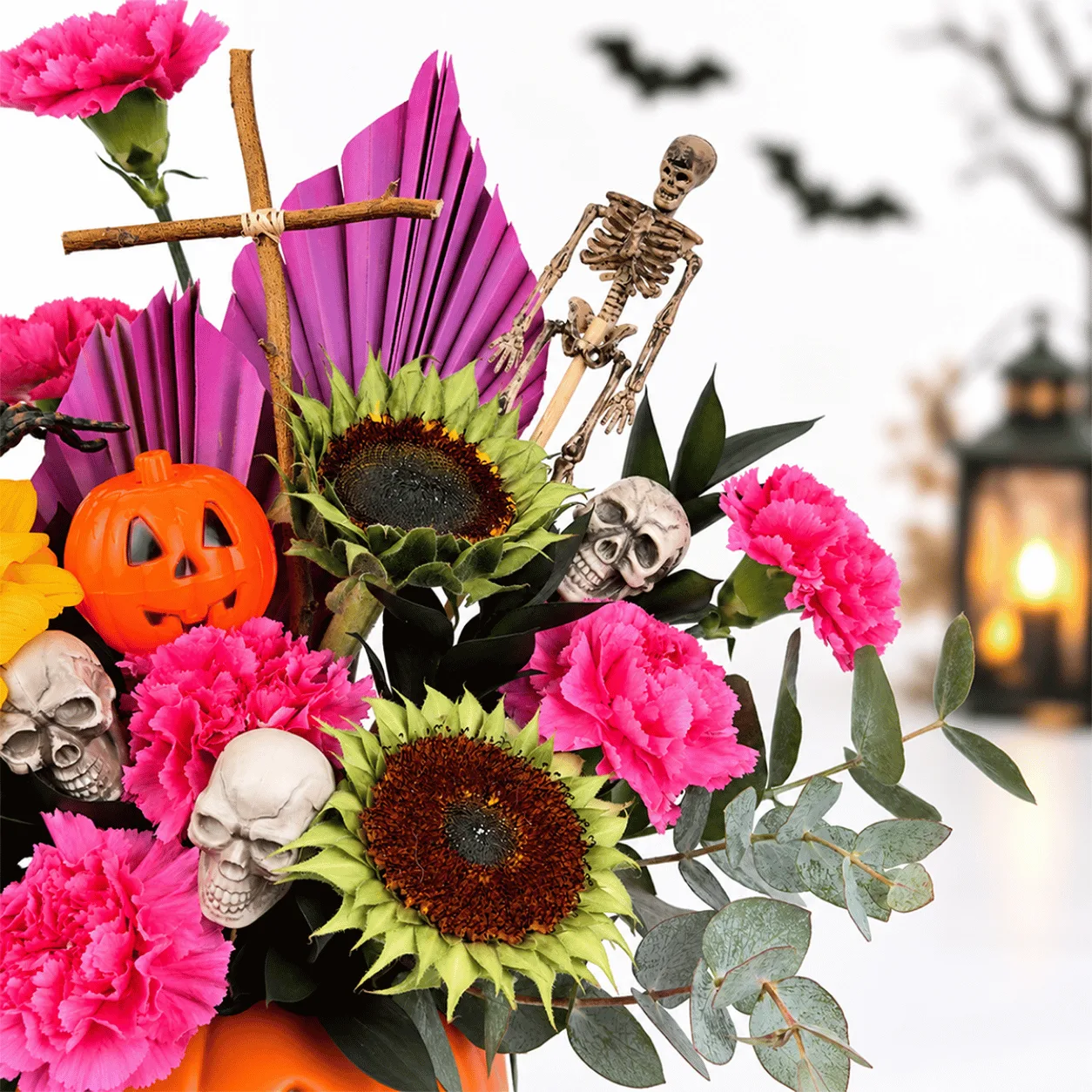 Side view of Pumpkin Magic Halloween Floral Arrangement showcasing colorful fresh flowers and festive Halloween accents.