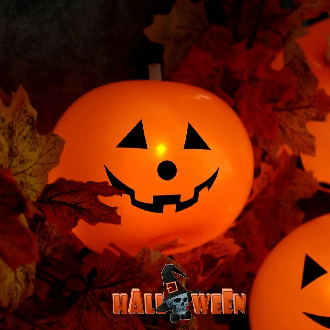 Close-up of Halloween LED Light Up Pumpkin Balloons featuring spooky pumpkin faces and bright glowing LED lights.