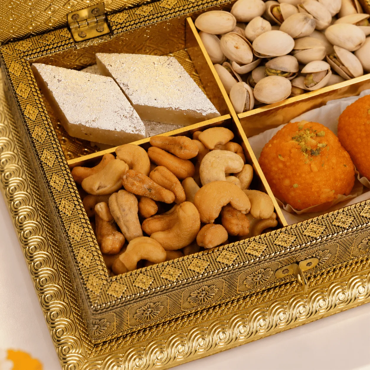 Open Shahi Swarna Diwali gift box displaying beautifully arranged mithai and dry fruits in elegant festive packaging.