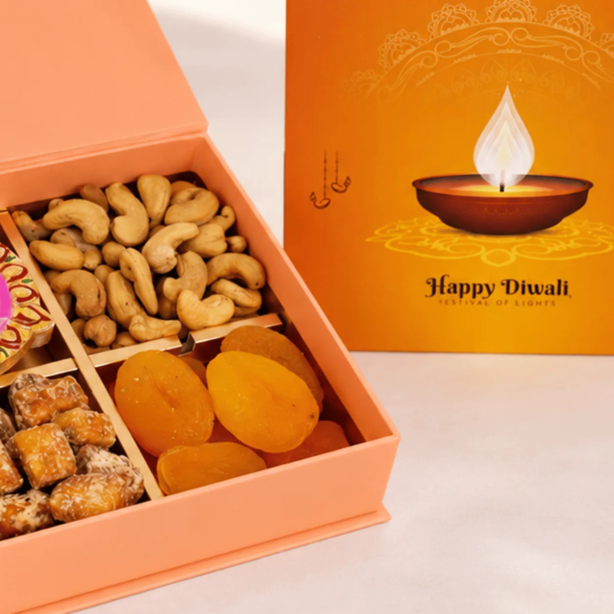 Elegant side view of Diwali Dry Fruits & Diya Gift Box with festive packaging and decorative details.