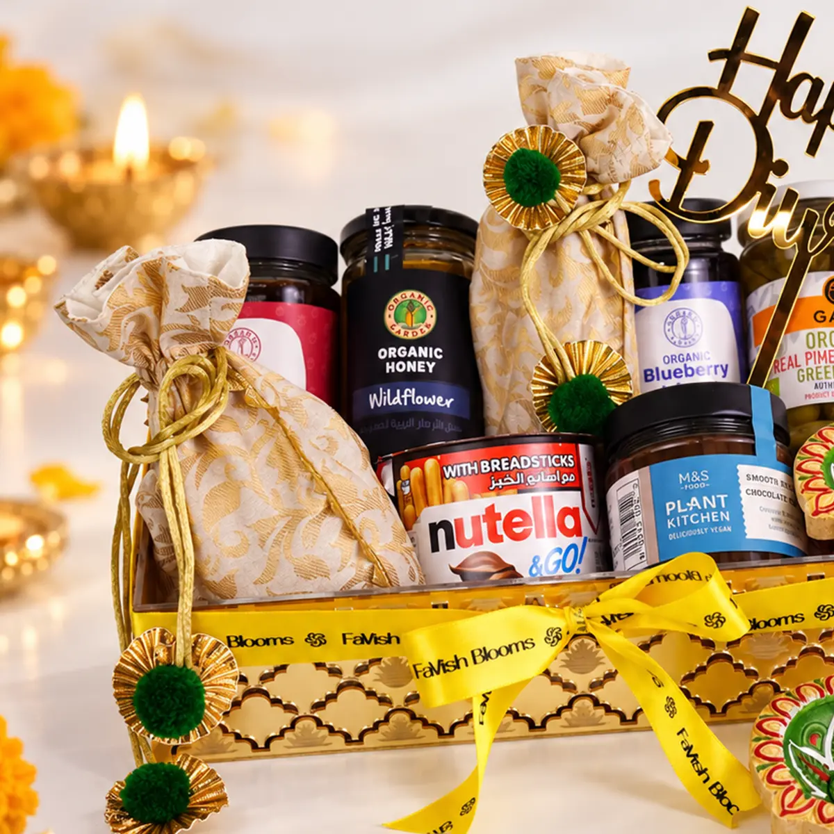 Premium Diwali gourmet hamper with honey, blueberry jam, chocolate spread, and festive gift decorations.