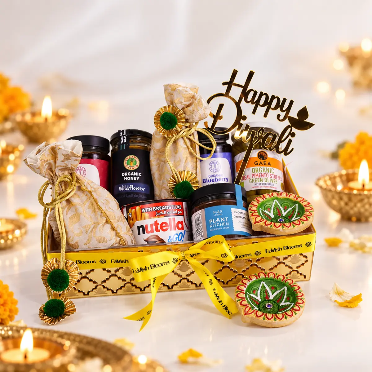 Luxury Diwali gourmet gift hamper with sweets, organic treats, decorative diyas, and golden packaging by FaVish Blooms.