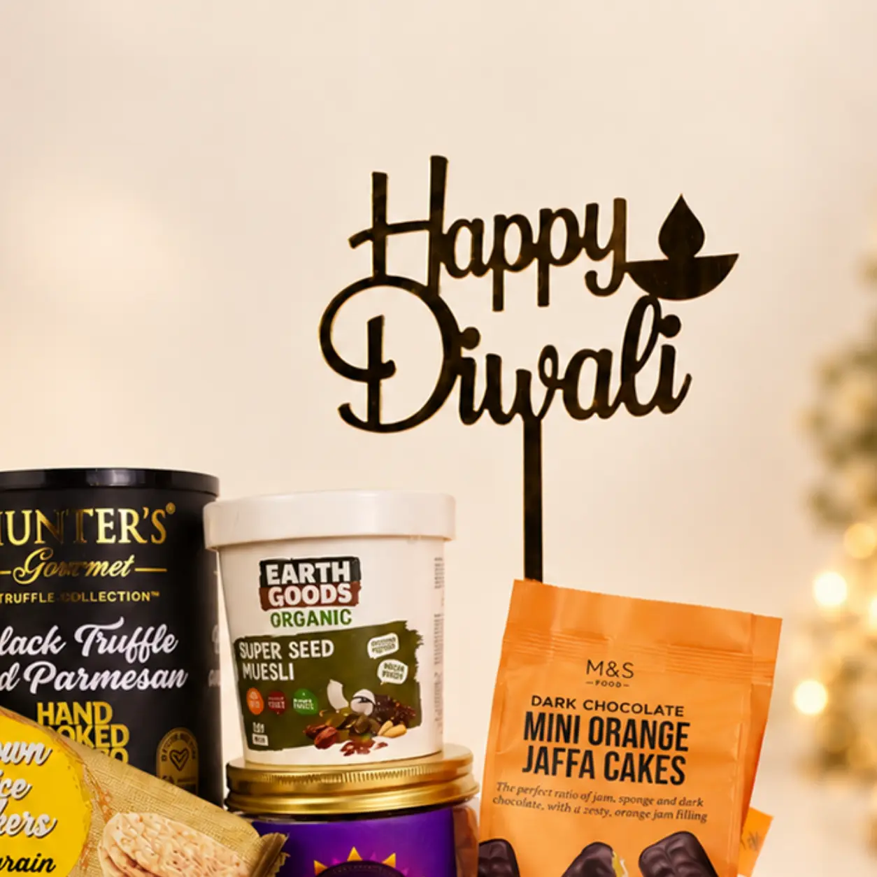 Happy Diwali decorative topper with gourmet snacks, muesli, and chocolate treats.