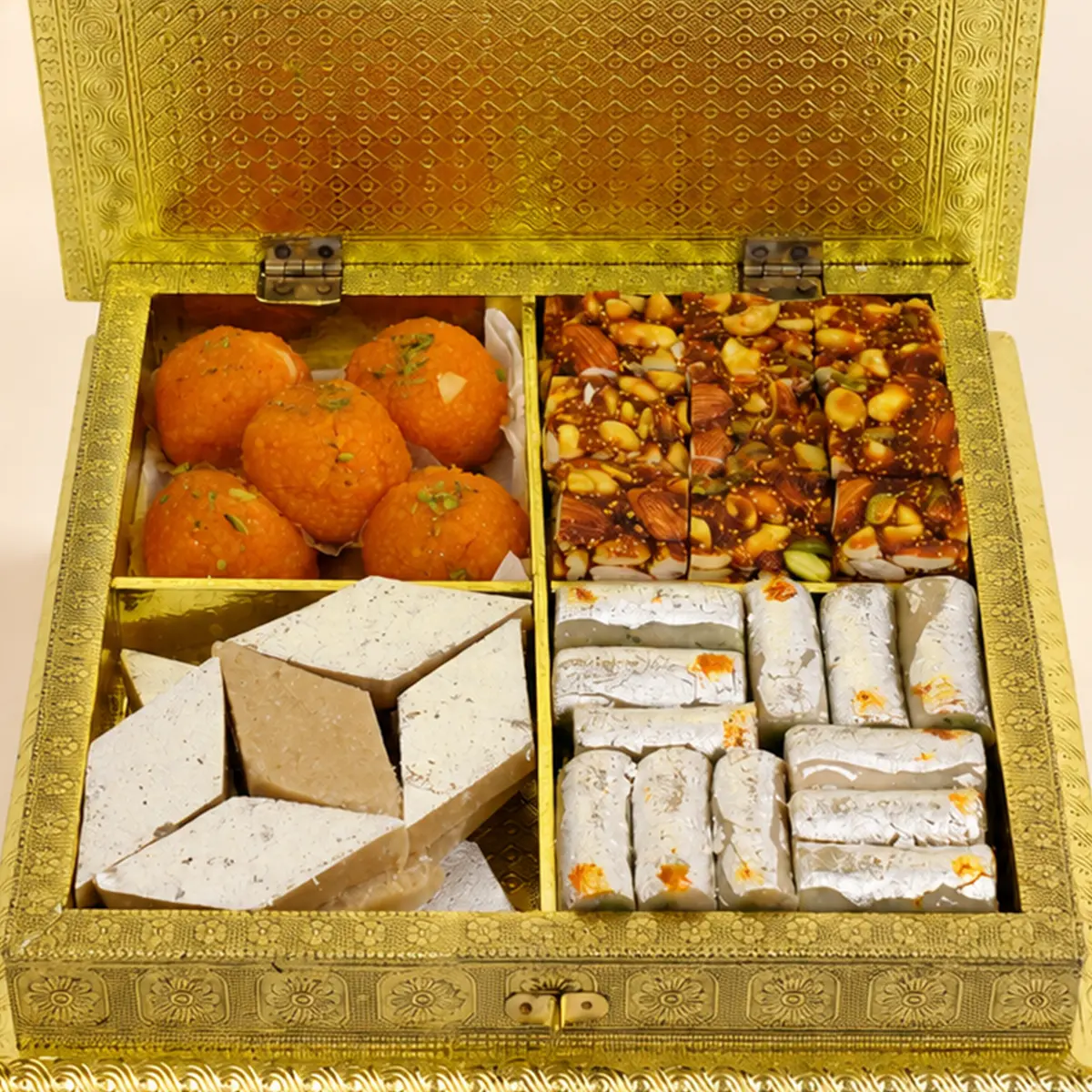 Luxury Diwali mithai gift box with motichoor laddoos, kaju katli, dry fruit chikki, and silver-coated sweets.