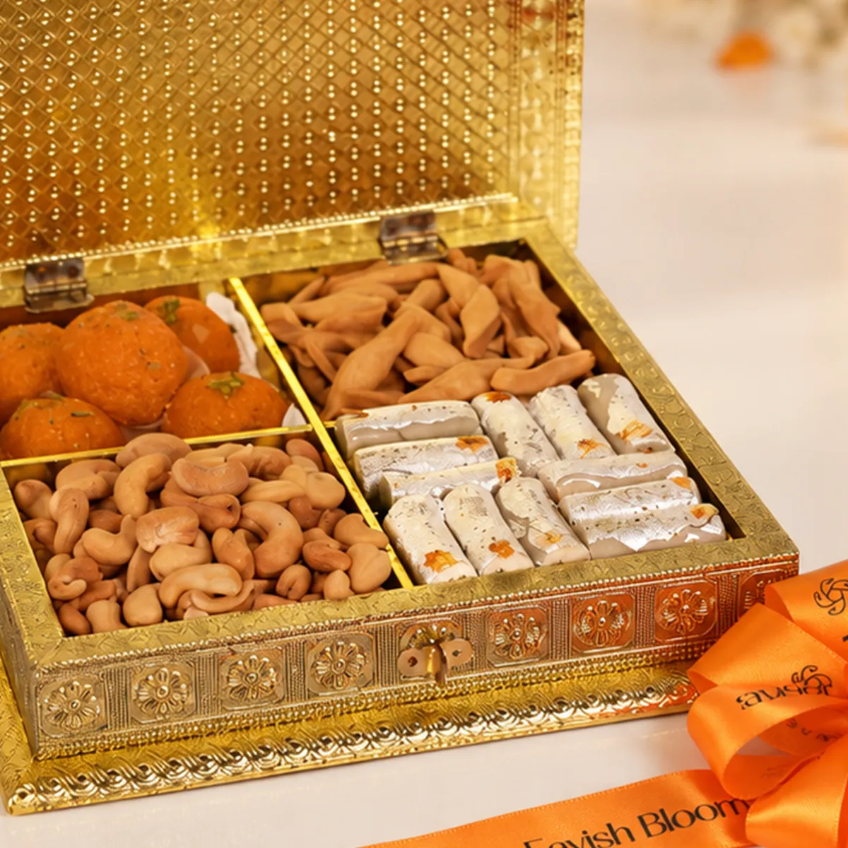 Close-up of premium Diwali gift box featuring traditional Indian sweets, roasted cashews, and savoury snacks.