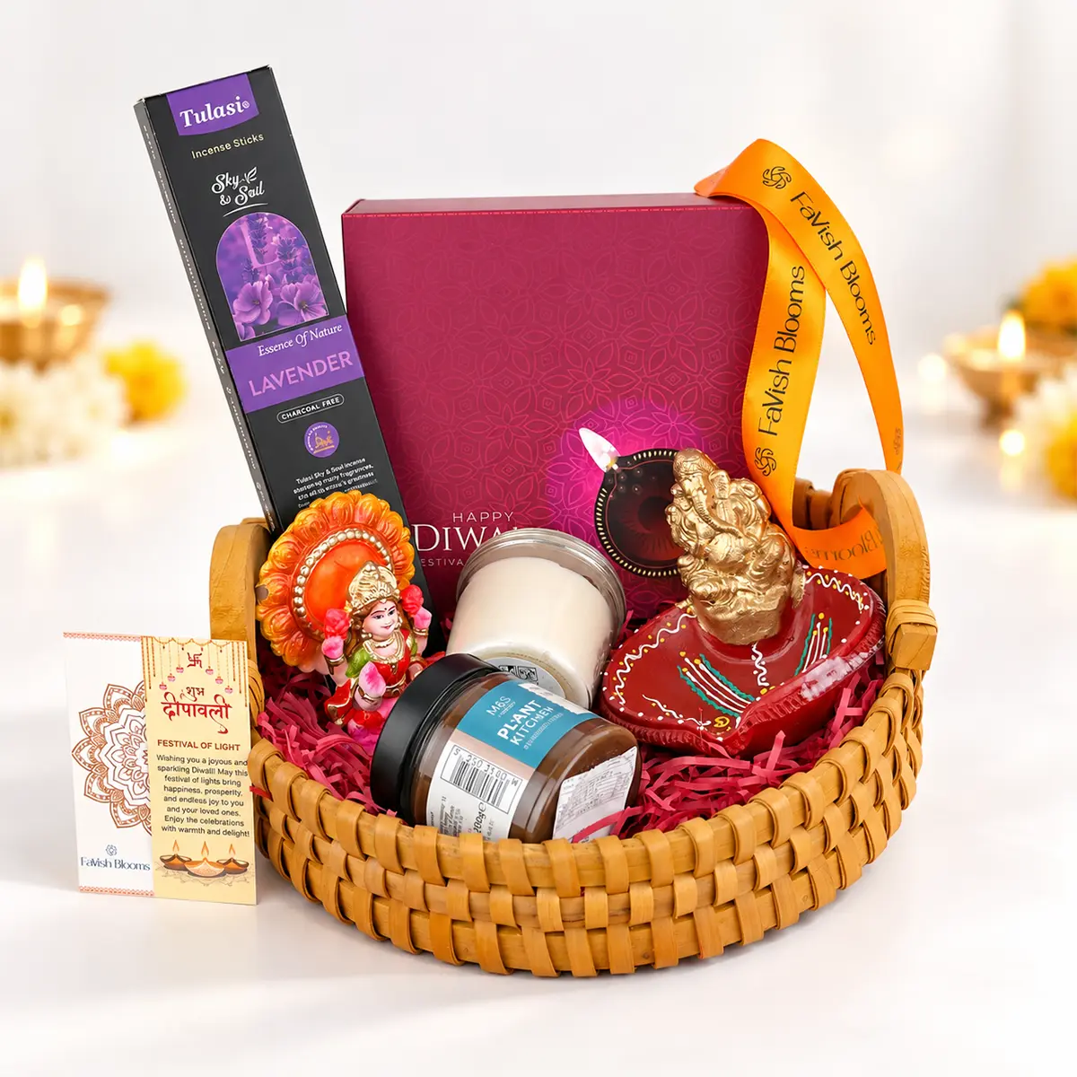 Premium Diwali gift basket with Lord Ganesha and Goddess Lakshmi idols, lavender incense sticks, scented candle, decorative diya, and festive gift box by FaVish Blooms.
