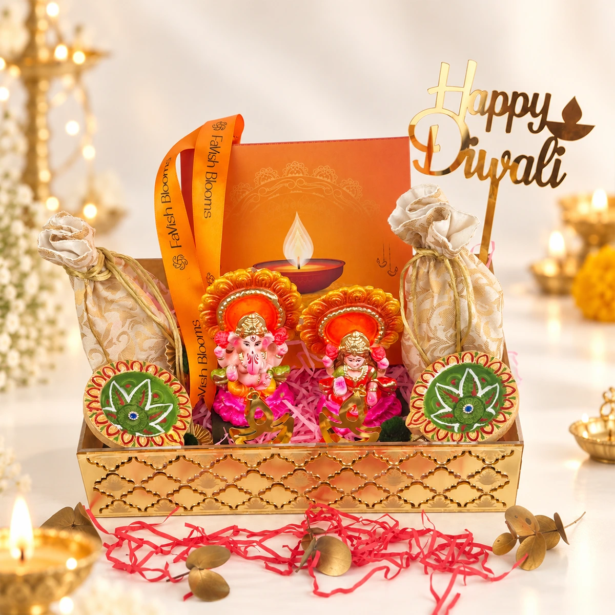 Luxury Diwali gift tray featuring Lord Ganesha and Goddess Lakshmi idols, decorative diyas, festive gift pouches, and Happy Diwali topper by FaVish Blooms.